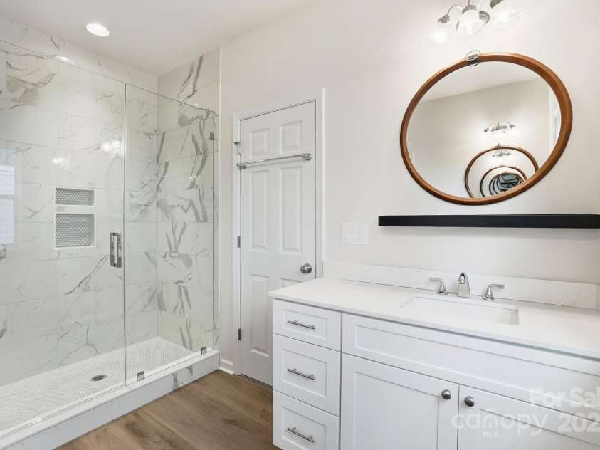 17909 Wilbanks Drive, Charlotte, NC 28278.  MLS# CAR4310693, YatesRealty ID 1094. Primary bath with dual vanities and walk-in tile shower