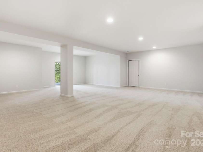 17909 Wilbanks Drive, Charlotte, NC 28278.  MLS# CAR4310693, YatesRealty ID 1094. The walk-out lower level is designed for entertaining with a spacious recreation room, plus an unfinished area ready for your personal touch—whether it’s a home gym, theater, or extra storage