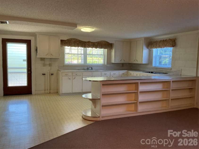 219 Central Avenue, Locust, NC 28097.  MLS# CAR4368249, YatesRealty ID 10940. Basement kitchen