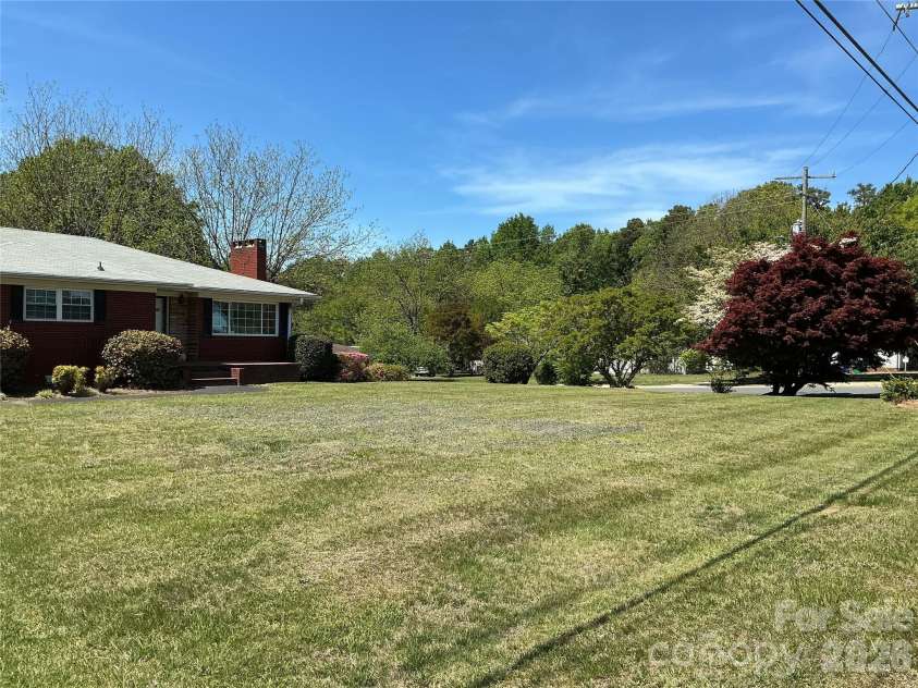 219 Central Avenue, Locust, NC 28097.  MLS# CAR4368249, YatesRealty ID 10940. Beautiful lawn and shrubs