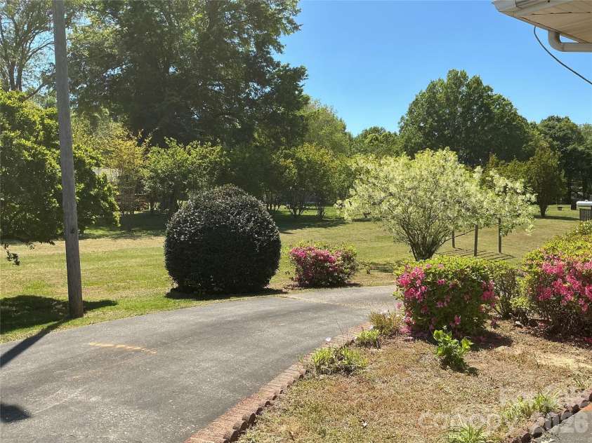 219 Central Avenue, Locust, NC 28097.  MLS# CAR4368249, YatesRealty ID 10940. Circular concrete driveway