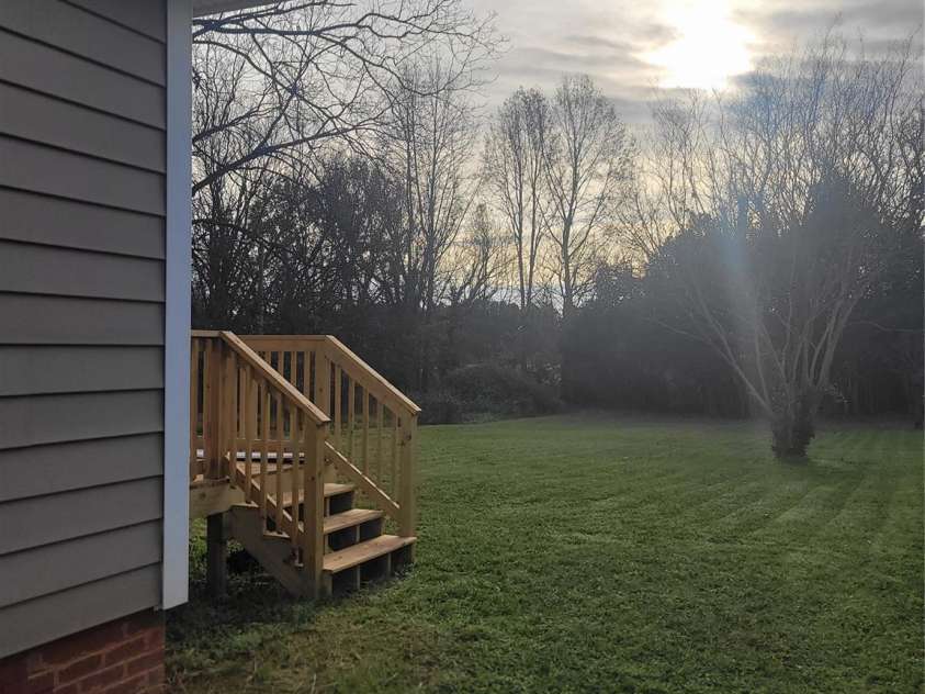 401 Woodlawn Avenue, Cramerton, NC 28032.  MLS# CAR4193878, YatesRealty ID 10945. Deck Stairs leading to Oversized Backyard