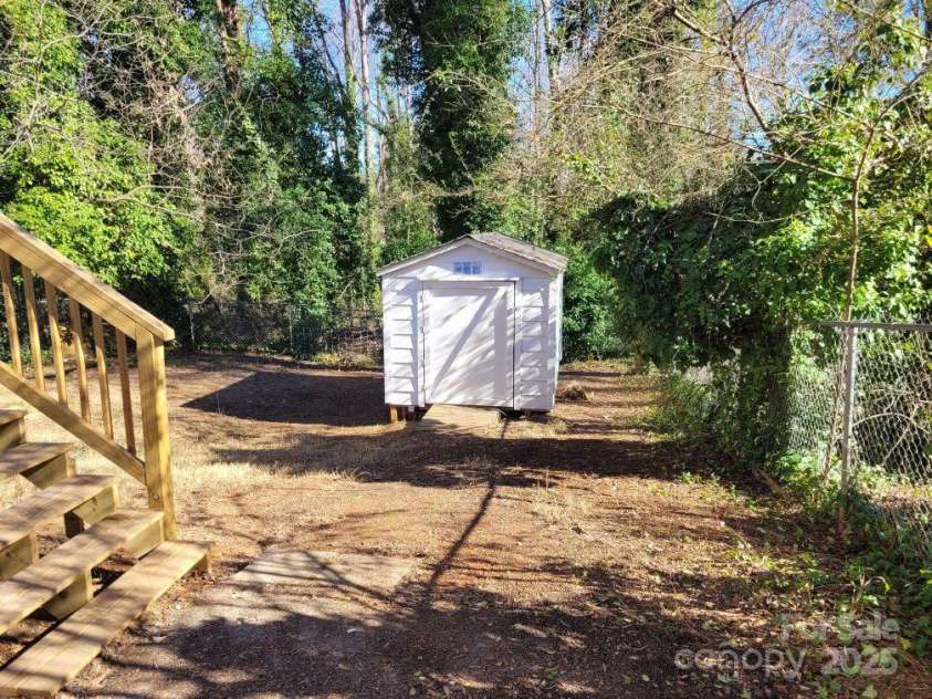 1116 East Drive, Gastonia, NC 28052.  MLS# CAR4211550, YatesRealty ID 10947. Storage Building and Deck stairs leading to Backyard