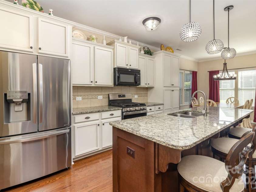 116 Water Ski Drive, Statesville, NC 28677.  MLS# CAR4239972, YatesRealty ID 10957. Kitchen with lots of cabinetry and a large island plus breakfast area.  Dishwasher and sink are in the island.  Gas range.