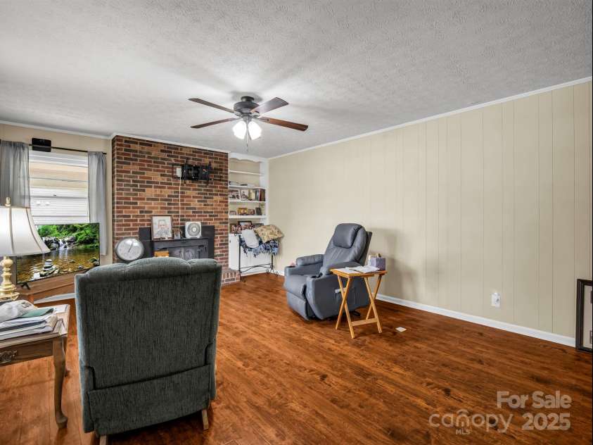 501 Weaver Street, Cherryville, NC 28021.  MLS# CAR4287583, YatesRealty ID 1096. Living room with woodburning fireplace