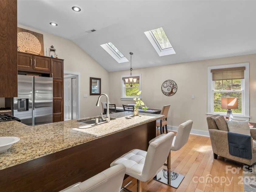 11 Hunting Lodge Drive, Black Mountain, NC 28711.  MLS# CAR4244815, YatesRealty ID 10963. Kitchen with breakfast bar and skylights that showcase the moon!