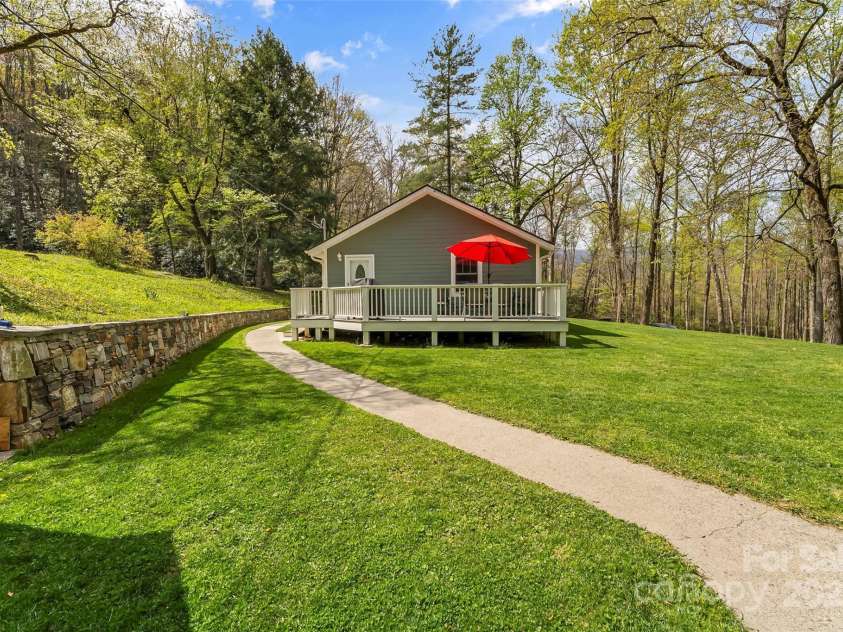 11 Hunting Lodge Drive, Black Mountain, NC 28711.  MLS# CAR4244815, YatesRealty ID 10963. Sidewalk creates a clean path to the guest house through the well-manicured lawn.