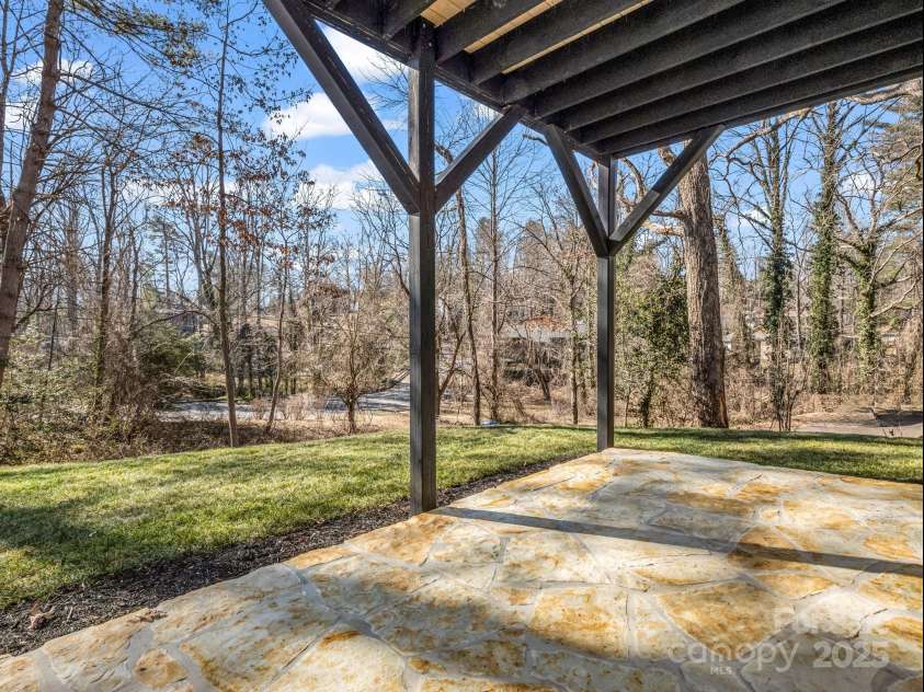 1104 Sylvan Boulevard, Hendersonville, NC 28791.  MLS# CAR4215547, YatesRealty ID 10973. Rock patio under covered deck