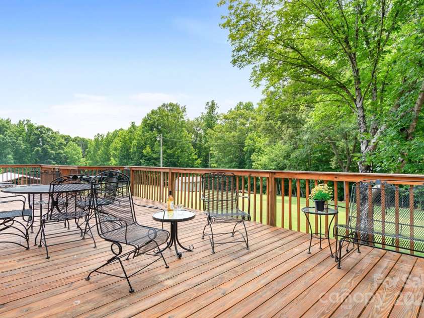 4299 Randleman Road, Iron Station, NC 28080.  MLS# CAR4159098, YatesRealty ID 10975. What a beautiful natural scene from the rear deck.  Great entertaining space and plenty of room for grilling, relaxing.