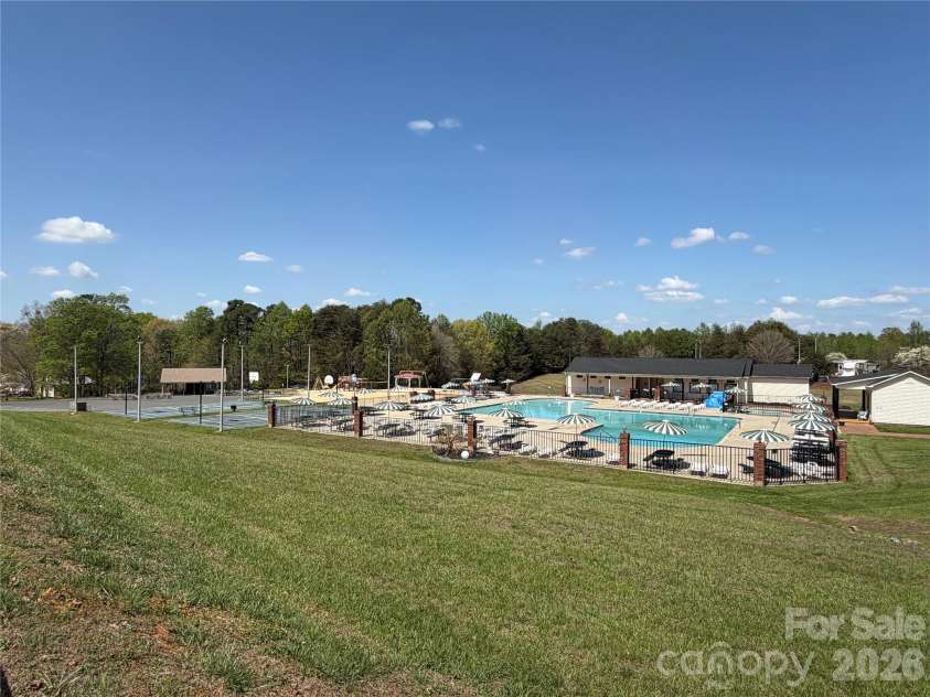 156 Marina Drive, New London, NC 28127.  MLS# CAR4365180, YatesRealty ID 10981. Community pool