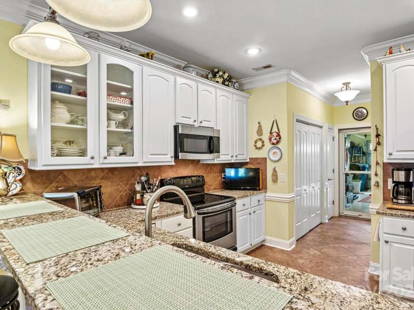 1119 21st Avenue, Hickory, NC 28601.  MLS# CAR4248559, YatesRealty ID 10982. Kitchen Breakfast Bar/Garage Entry View