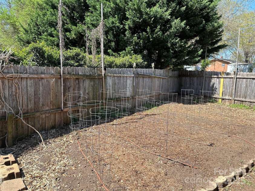 207 Lakeside Avenue, Davidson, NC 28036.  MLS# CAR4239129, YatesRealty ID 10998. Backyard garden w drip irrigation