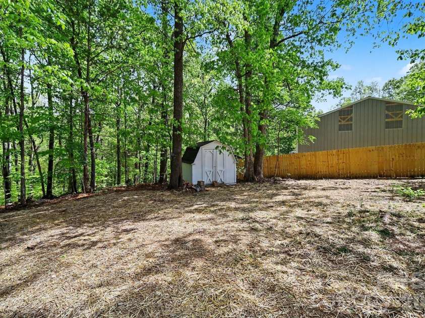11630 Trails End Lane, Huntersville, NC 28078.  MLS# CAR4342080, YatesRealty ID 11011. Privacy fencing and storage building 