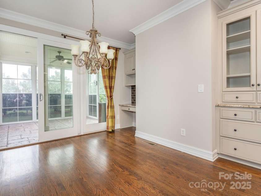 3850 Hounslow Lane, Harrisburg, NC 28075.  MLS# CAR4216435, YatesRealty ID 11023. Breakfast area looks out into the sun porch and the large back yard