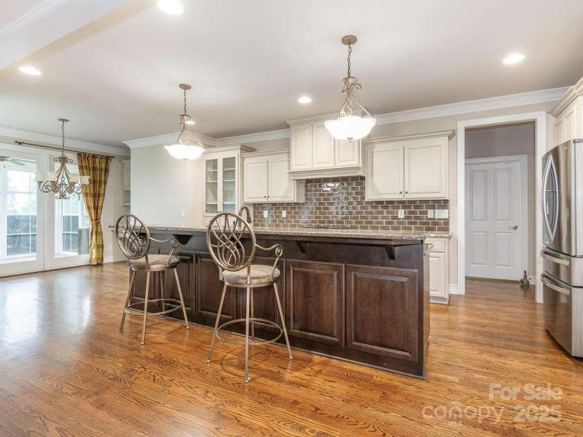 3850 Hounslow Lane, Harrisburg, NC 28075.  MLS# CAR4216435, YatesRealty ID 11023. Kitchen has granite counter tops, tile backsplash