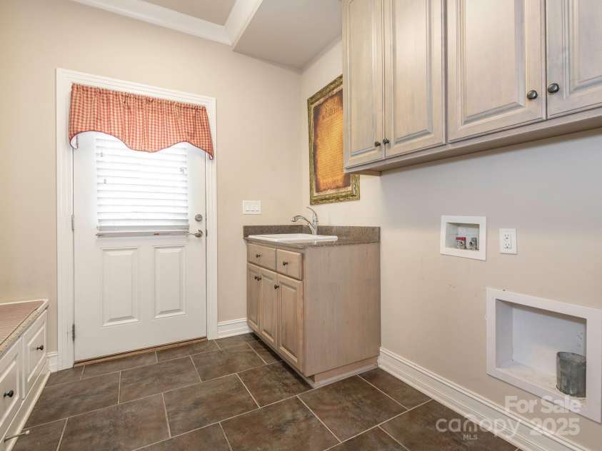 3850 Hounslow Lane, Harrisburg, NC 28075.  MLS# CAR4216435, YatesRealty ID 11023. Laundry room/drop zone area with cabinets and sink
