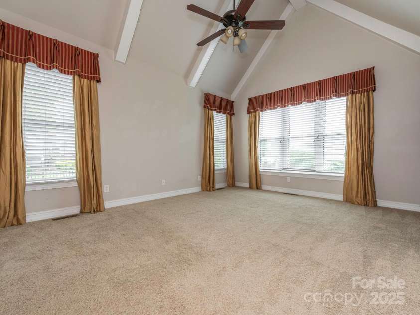 3850 Hounslow Lane, Harrisburg, NC 28075.  MLS# CAR4216435, YatesRealty ID 11023. Main-level primary suite with vaulted ceiling and built ins