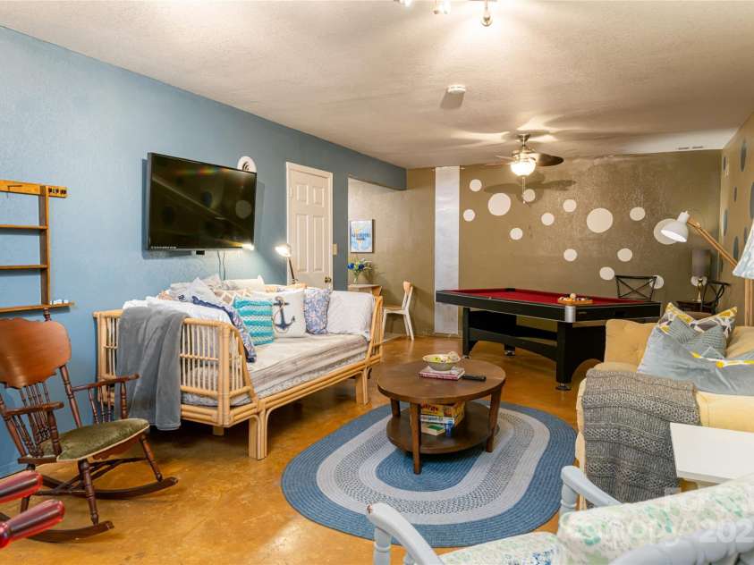 39 Kirkland Drive, Asheville, NC 28805.  MLS# CAR4325951, YatesRealty ID 11024. Basement apartment living room area