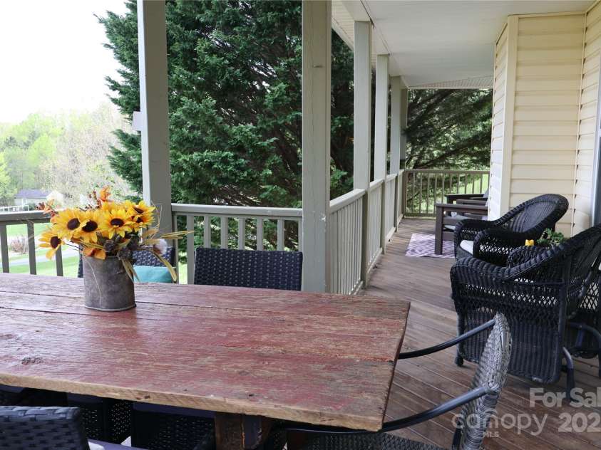 39 Kirkland Drive, Asheville, NC 28805.  MLS# CAR4325951, YatesRealty ID 11024. Wrap around porch is lovely for sitting and watching the rain 