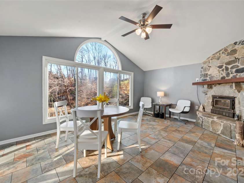 513 Paradise Circle, Belmont, NC 28012.  MLS# CAR4219509, YatesRealty ID 11053. Awesome dining area with fireplace and lake view