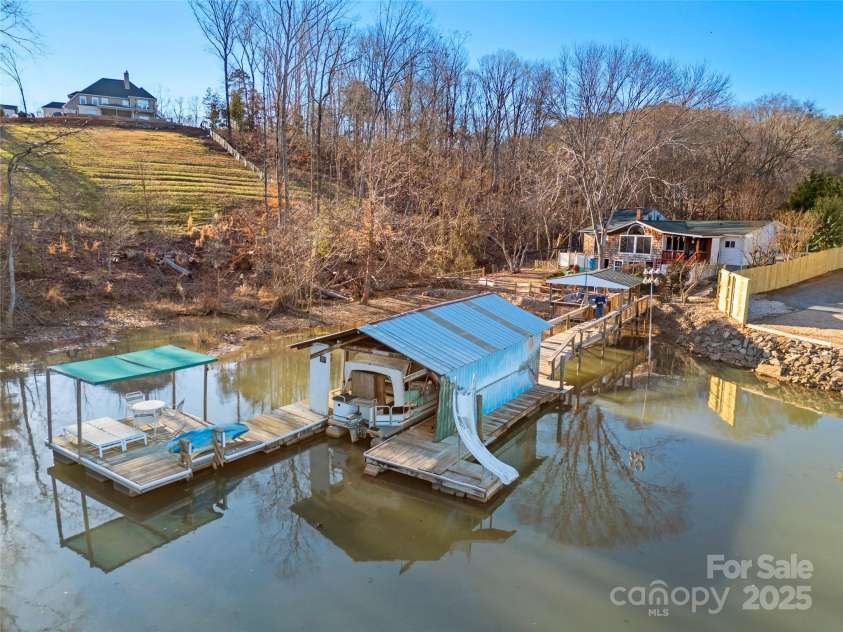 513 Paradise Circle, Belmont, NC 28012.  MLS# CAR4219509, YatesRealty ID 11053. Entertainment space plus covered boat slip plus floating dock!