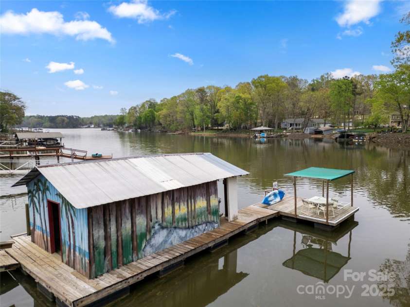513 Paradise Circle, Belmont, NC 28012.  MLS# CAR4219509, YatesRealty ID 11053. The enclosed boat house offers protection for your boat.