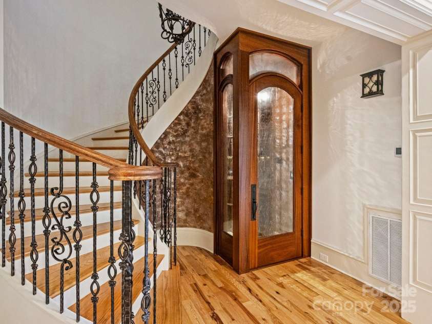 4400 Sharon View Road, Charlotte, NC 28226.  MLS# CAR4243534, YatesRealty ID 11056. Beautiful Wine Cellar under the winding staircase