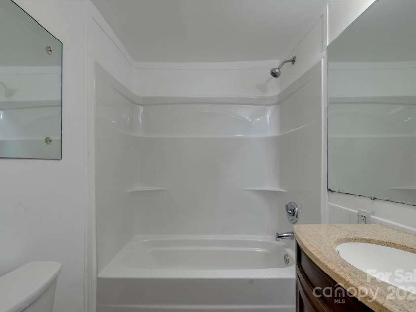 4 Morgan Cove Road, Candler, NC 28715.  MLS# CAR3898041, YatesRealty ID 11057. Bathroom has fiberglass tub and shower surround.