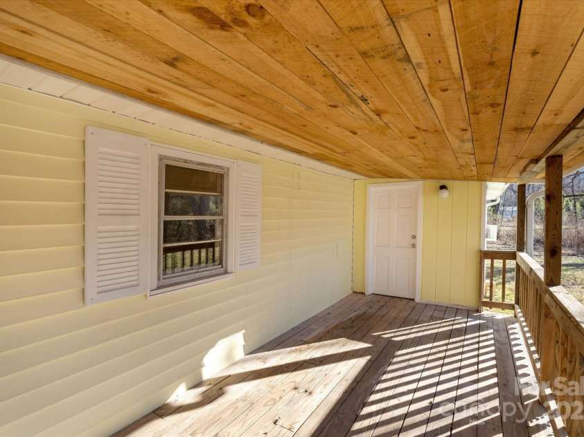 4 Morgan Cove Road, Candler, NC 28715.  MLS# CAR3898041, YatesRealty ID 11057. Covered rear porch.