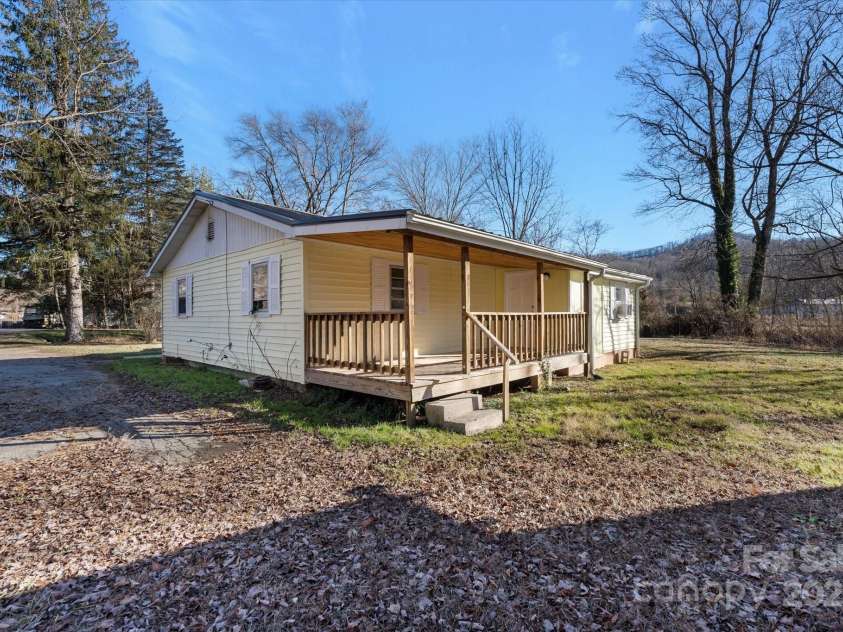 4 Morgan Cove Road, Candler, NC 28715.  MLS# CAR3898041, YatesRealty ID 11057. Covered rear porch allows entry to the mud/laundry room and is perfect for privately entertaining.