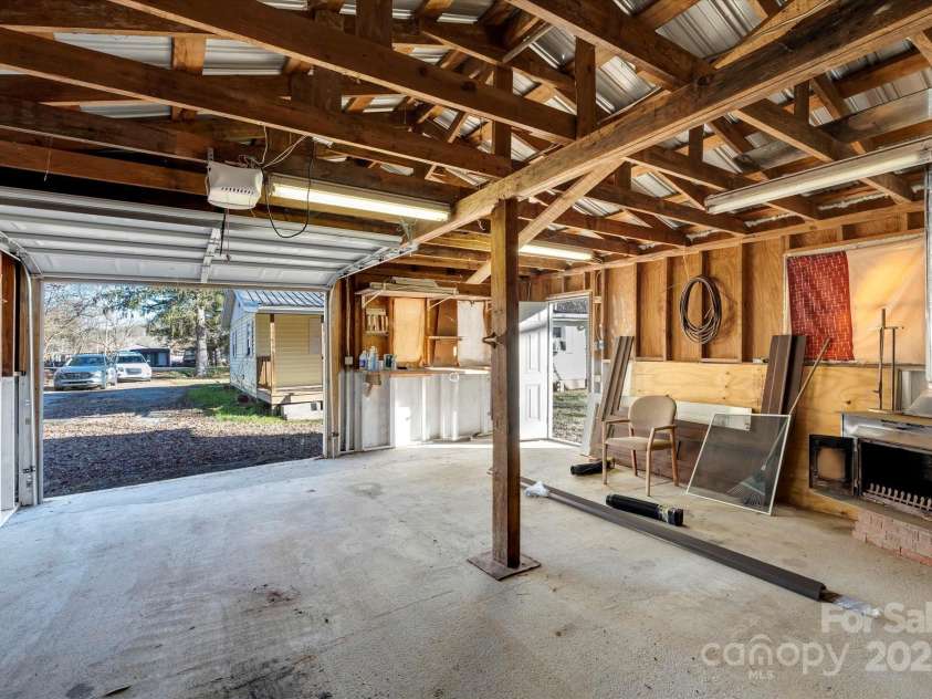 4 Morgan Cove Road, Candler, NC 28715.  MLS# CAR3898041, YatesRealty ID 11057. Garage also has exterior door on the right side.