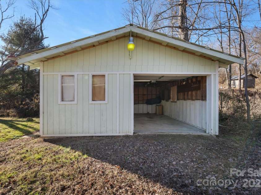 4 Morgan Cove Road, Candler, NC 28715.  MLS# CAR3898041, YatesRealty ID 11057. Oversized single car garage with room for storage and workshop.