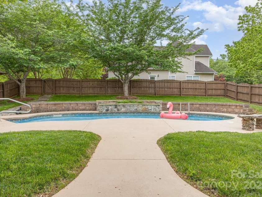 212 Horn Tassel Court, Indian Trail, NC 28079.  MLS# CAR4244678, YatesRealty ID 11066. Pool has large concrete deck.