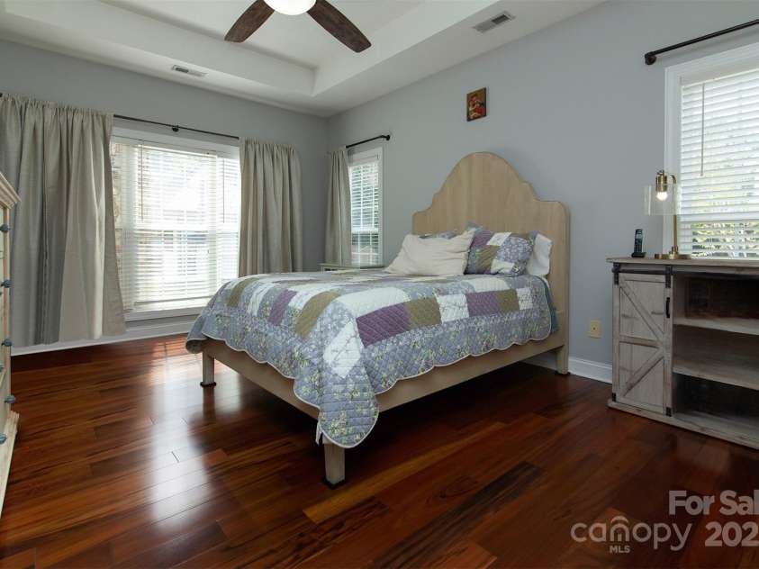 212 Horn Tassel Court, Indian Trail, NC 28079.  MLS# CAR4244678, YatesRealty ID 11066. Restful primary bedroom on the main level has a trey ceiling.