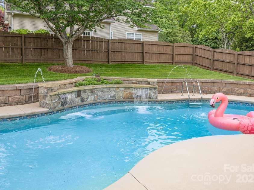 212 Horn Tassel Court, Indian Trail, NC 28079.  MLS# CAR4244678, YatesRealty ID 11066. Stone waterfall is a hit on a hot day.
