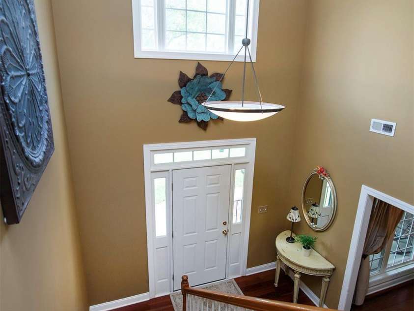 212 Horn Tassel Court, Indian Trail, NC 28079.  MLS# CAR4244678, YatesRealty ID 11066. The 2 story foyer features a large pretty window and wood stair case.