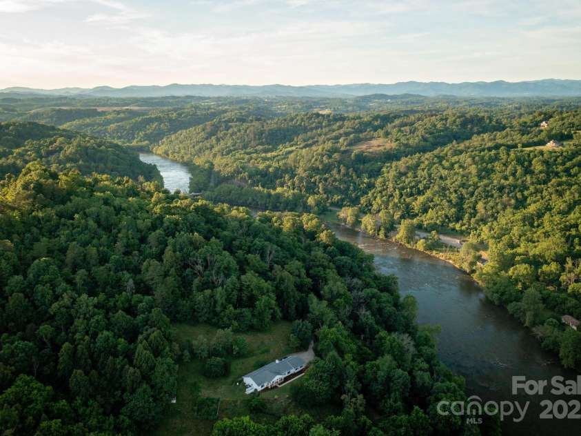 169 Chandler Road, Alexander, NC 28701.  MLS# CAR4226773, YatesRealty ID 11077. Perched up high - trim trees for River Views!