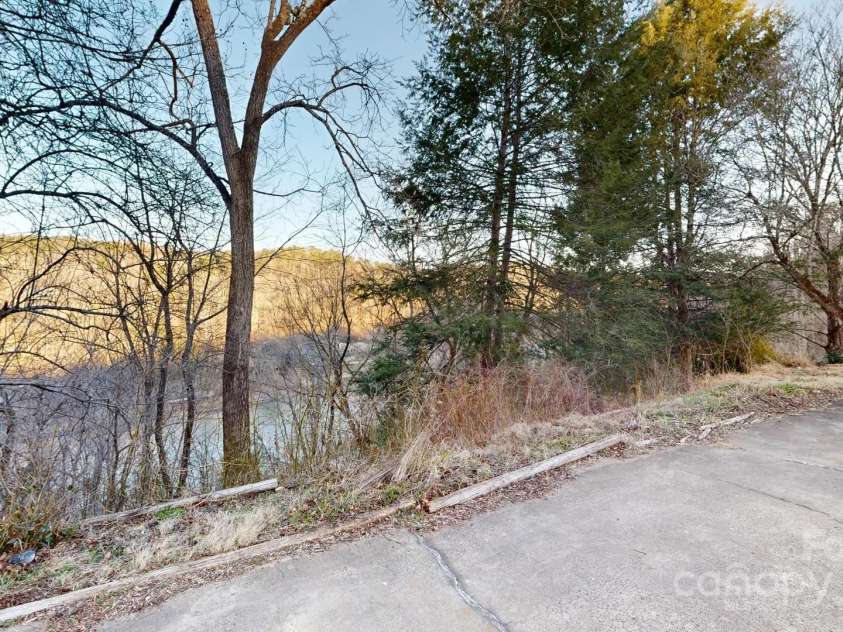 169 Chandler Road, Alexander, NC 28701.  MLS# CAR4226773, YatesRealty ID 11077. Trim trees for expansive French Broad River Views!