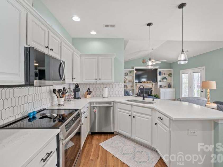 16515 Amberside Road, Cornelius, NC 28031.  MLS# CAR4366674, YatesRealty ID 11103. Stainless appliances and pendant lighting