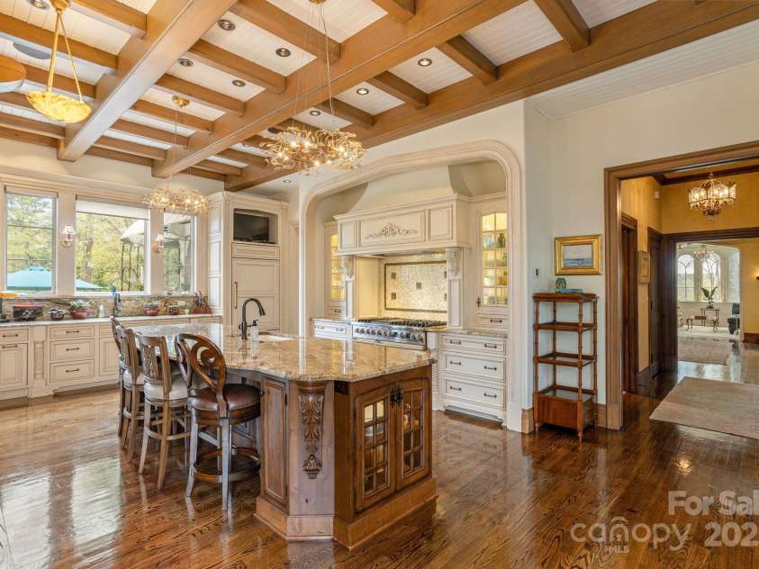 8 Fairway Place, Asheville, NC 28803.  MLS# CAR4245541, YatesRealty ID 11110. Step into a culinary masterpiece where French country charm harmoniously blends with modern functionality.