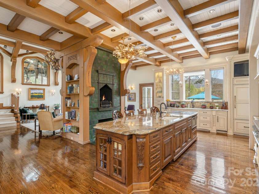 8 Fairway Place, Asheville, NC 28803.  MLS# CAR4245541, YatesRealty ID 11110. The kitchen boasts a professional-grade gas range and double ovens, catering to both everyday meals and grand entertaining.
