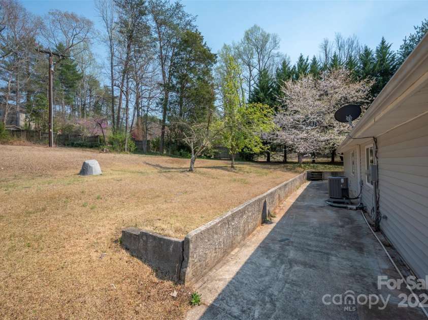 163 Woodland Drive, Columbus, NC 28722.  MLS# CAR4240701, YatesRealty ID 11111. Back yard and patio