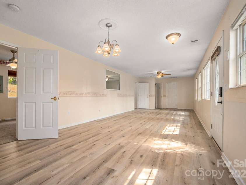 163 Woodland Drive, Columbus, NC 28722.  MLS# CAR4240701, YatesRealty ID 11111. Combination living and dining room with luxury vinyl plank flooring