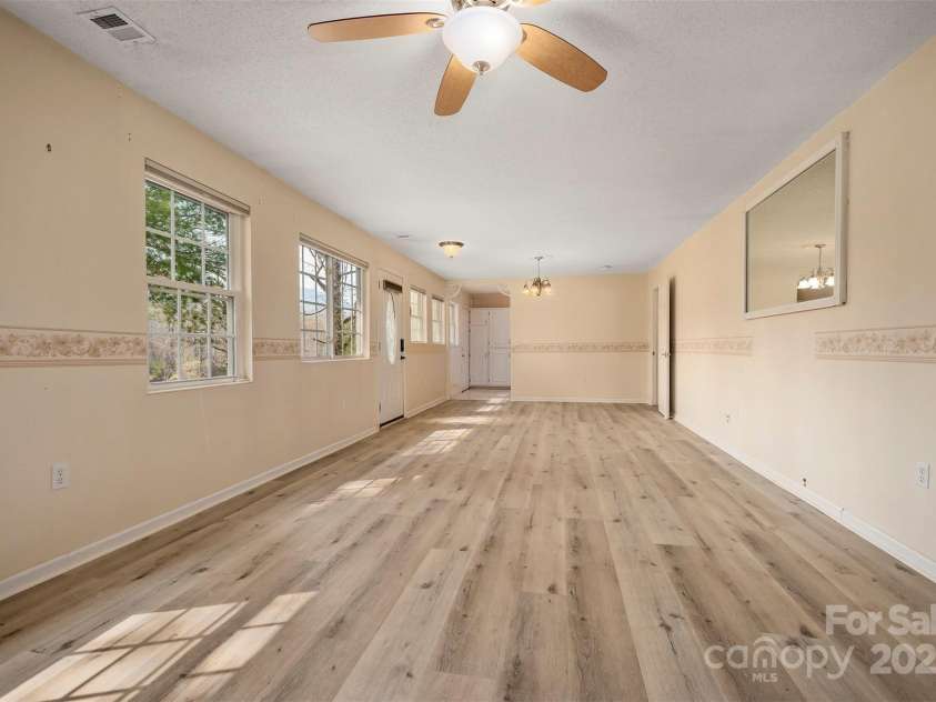 163 Woodland Drive, Columbus, NC 28722.  MLS# CAR4240701, YatesRealty ID 11111. Looking back toward the kitchen and a guest bedroom with en suite bathroom is on the right