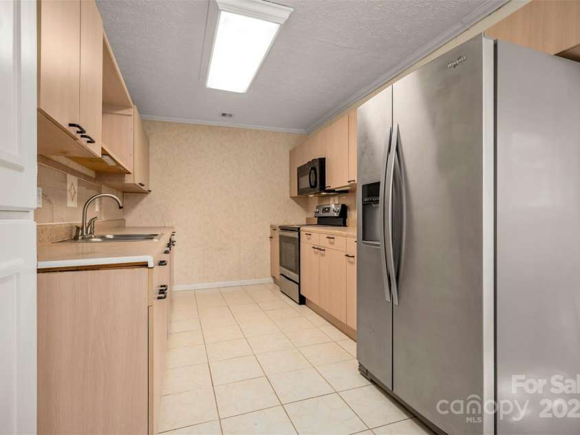163 Woodland Drive, Columbus, NC 28722.  MLS# CAR4240701, YatesRealty ID 11111. Tile flooring in the kitchen