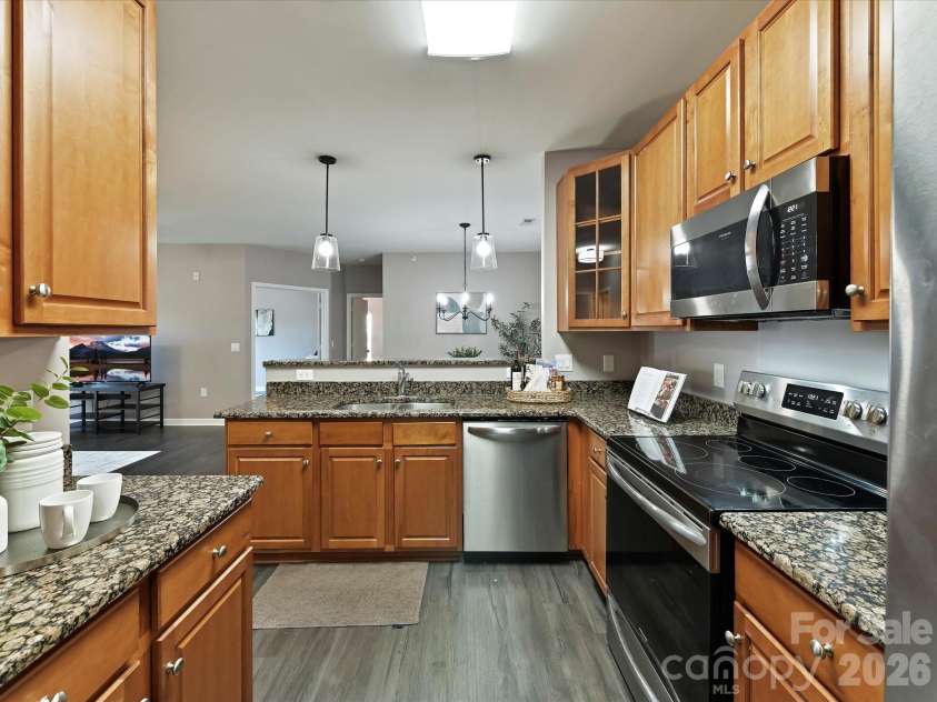 9145 Mcdowell Creek Court, Cornelius, NC 28031.  MLS# CAR4336946, YatesRealty ID 11148. Kitchen features granite counters, stainless steel appliances, plenty of cabinets for storage, breakfast bar & dining area! 