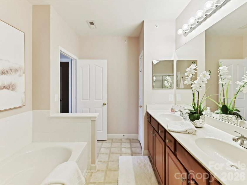9145 Mcdowell Creek Court, Cornelius, NC 28031.  MLS# CAR4336946, YatesRealty ID 11148. Primary Bath features dual vanity, garden tub & separate shower!