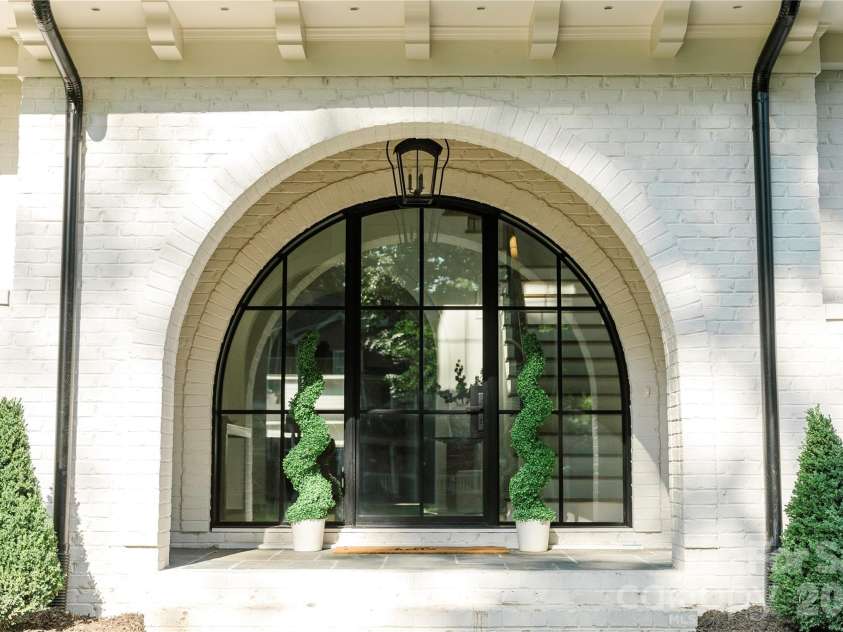 1118 Kingscross Drive, Charlotte, NC 28211.  MLS# CAR4326781, YatesRealty ID 1118. Images depict a similar home previously built by the builder with comparable features. Selections, finishes, and specifications may vary. Visual reference only.entry/steel arch doors.
