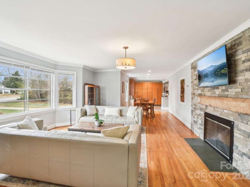 64 Alexander Road, Weaverville, NC 28787.  MLS# CAR4252153, YatesRealty ID 11181. Living Room with stone fireplace