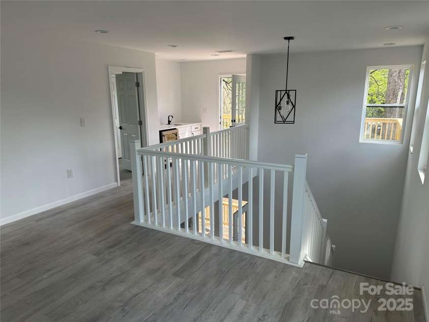 1413 Hateras Avenue, Charlotte, NC 28216.  MLS# CAR4246370, YatesRealty ID 11196. Premium loft with Wet Bar and balcony access for entertaining